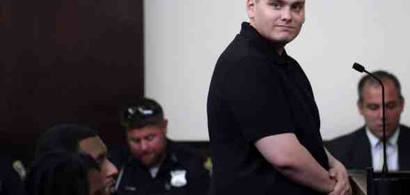 Leader of white supremacist group NSC-131 Chris Hood smiles at the camera while in court