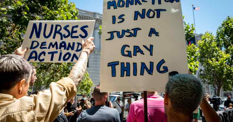A person holds a sign reading: 'Monkeypox is not just a gay thing'