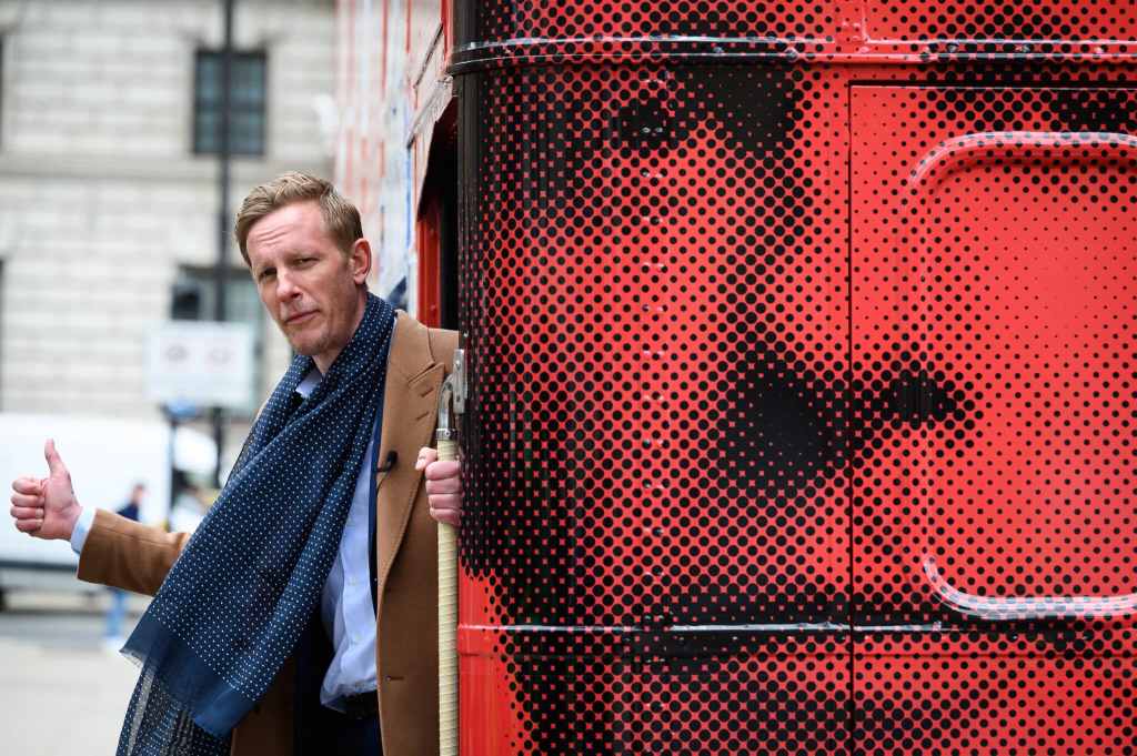 Laurence Fox leans out from the rear of his battle bus a