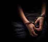 A teenagers hands in handcuffs