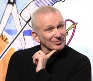 Jean Paul Gaultier during the "Fashion Freak Show" launch in black top smirking at camera