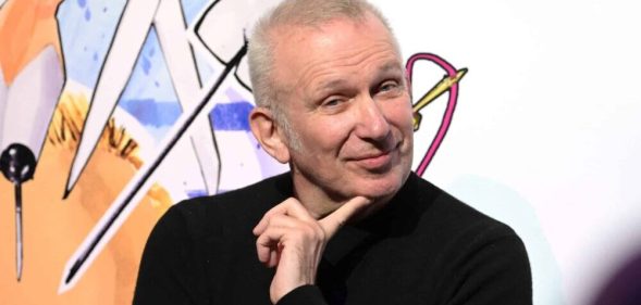 Jean Paul Gaultier during the "Fashion Freak Show" launch in black top smirking at camera