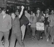 Mark at the Stonewall riots in 1969, pictured at the front with his arm raised.