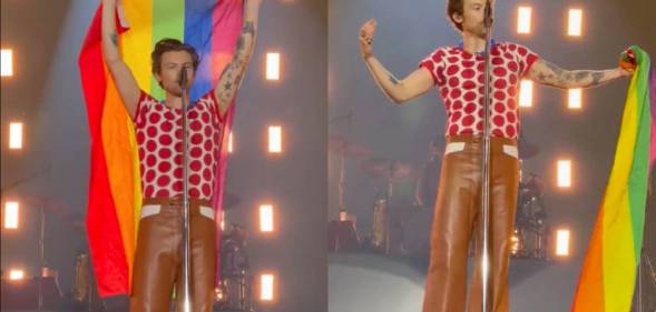 Harry Styles holds up an LGBTQ+ pride flag as he stands on stage during a concert in Oslo Norway