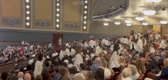 Students at the University of Michigan walk out of the white coat ceremony