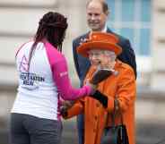 Queen Elizabeth II presents the Commonwealth Games baton to British Paralympic athlete Kadeena Cox.