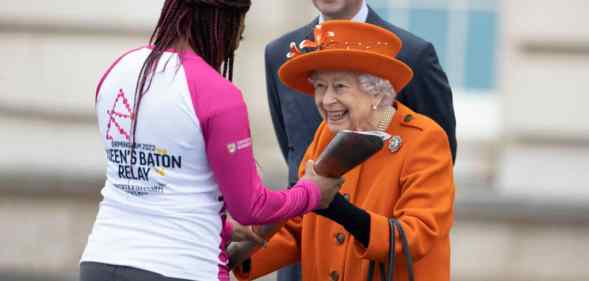 Queen Elizabeth II presents the Commonwealth Games baton to British Paralympic athlete Kadeena Cox.