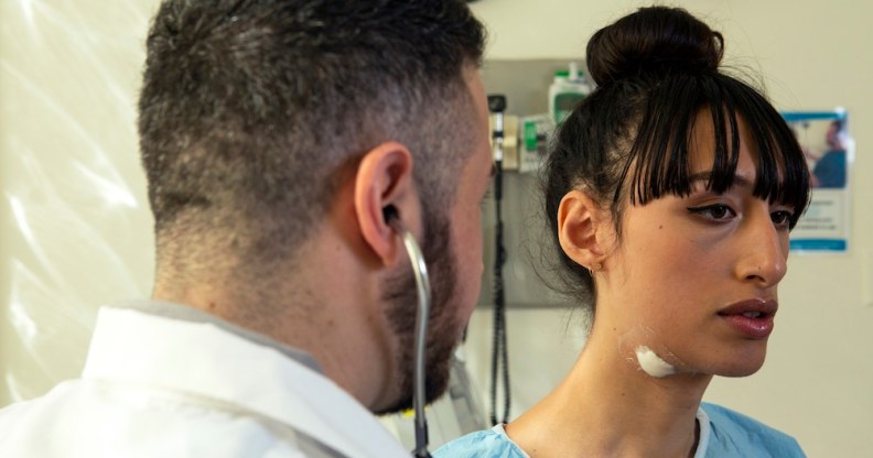 A trans woman in a hospital gown