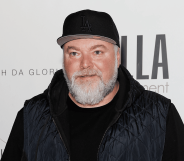 Kyle Sandilands stands for a red carpet photoshoot.