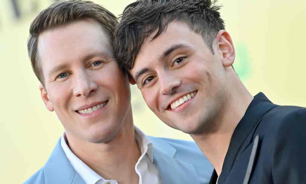 A photo of Dustin Lance Black and Tom Daley posed together
