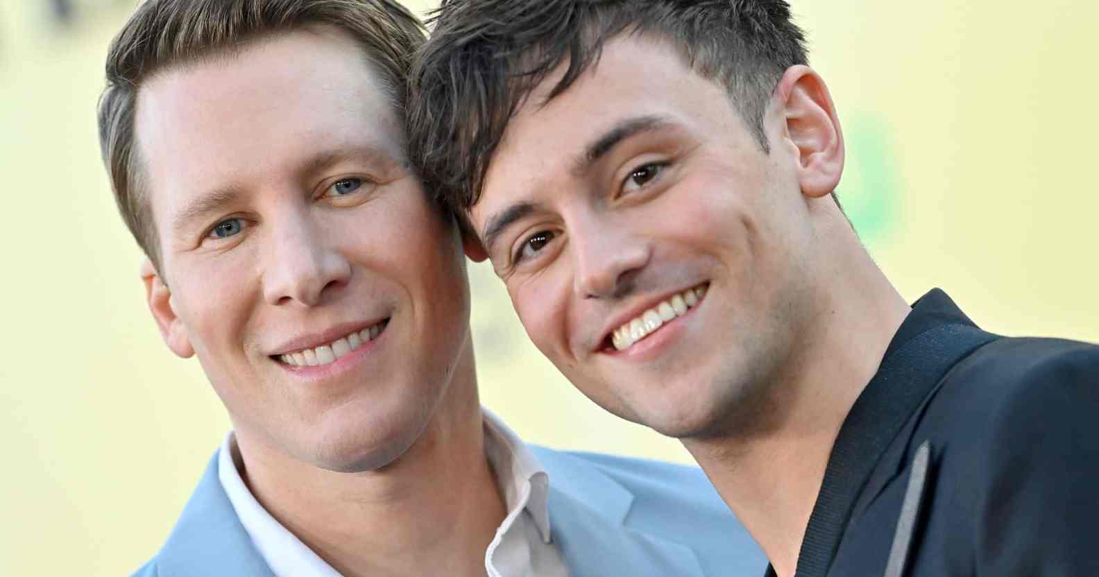 A photo of Dustin Lance Black and Tom Daley posed together