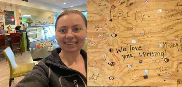 In the photograph on the right, Corrina Sac wears a dark sweatshirt as she takes a self inside UpRising Bakery and Cafe. The photograph on the right shows boards with words of support after the bakery was vandalised over a planned family-friendly drag event
