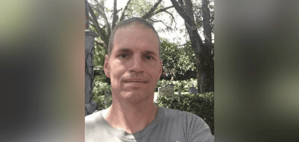 A portrait of far-right conspiracy theorist Ricky Shiffer in a park.