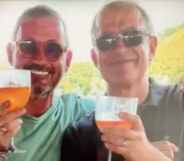 Walter Biot (left) and Uwe Hahn (Right) hold up drinks together.