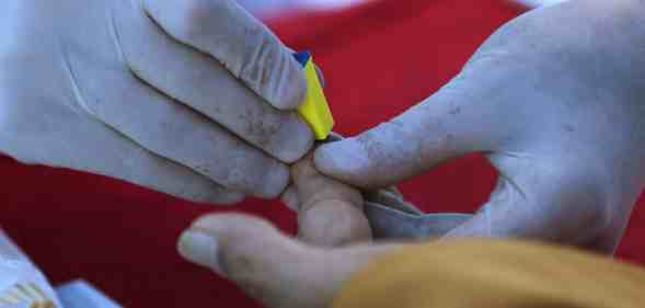 Someone taking a fingerprick test.