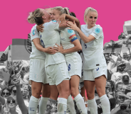 The England women's team embrace against a backdrop of black and white fans
