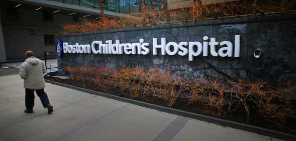 In this photograph, a pedestrian passes the Longwood Avenue exterior of the Boston Children's Hospital