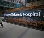 In this photograph, a pedestrian passes the Longwood Avenue exterior of the Boston Children's Hospital