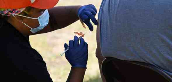 A public health worker wearing a face mask and surgical gloves administers the monkeypox vaccine at the Balboa Sports Center in the Encino neighborhood of Los Angeles, California, on July 27, 2022.