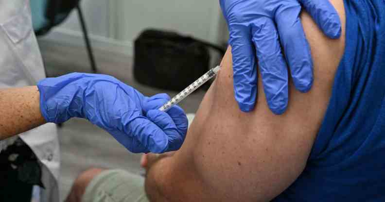 In this photograph, a nurse vaccinates a patient against monkeypox