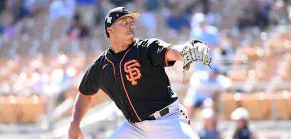 A baseball player in an oraneg