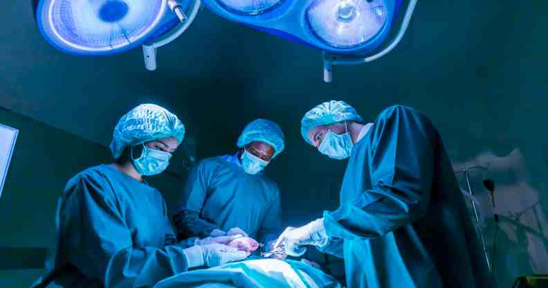 Team of surgeon doctors are performing heart surgery operation for patient