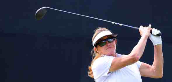In this photograph, Caitlyn Jenner swings a golf bat
