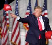 Donald Trump tosses hats to supporters at the rally Waukesha, Wisconsin