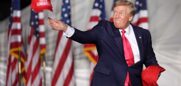 Donald Trump tosses hats to supporters at the rally Waukesha, Wisconsin