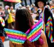 A girl wearing rainbow wings