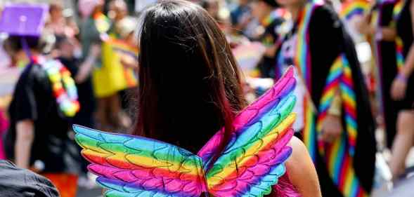A girl wearing rainbow wings