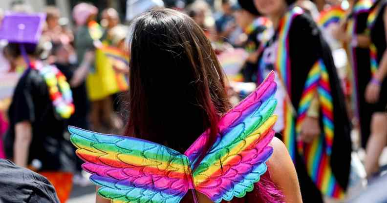 A girl wearing rainbow wings