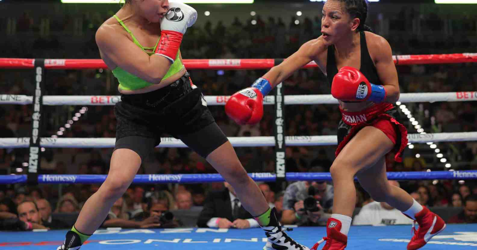 Eva Guzman (R) and Marlen Esparza (L) exchange punches
