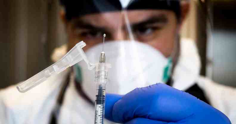 In this photograph, a medic repares a dose of the monkeypox vaccine
