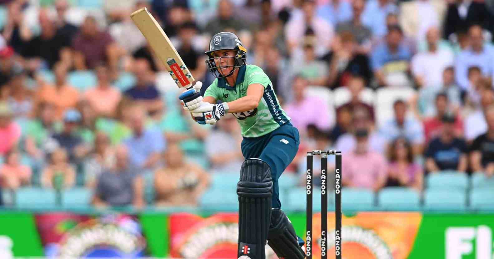 Lauren Winfield-Hil hitting out in cricket