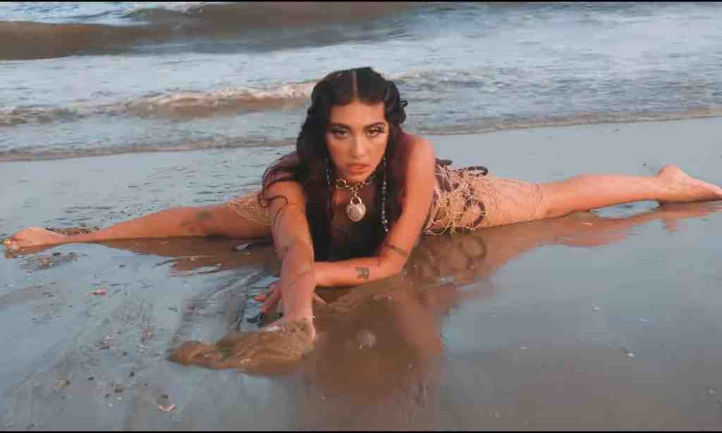 Lourdes Leon as Lolahol on a beach in her new music video