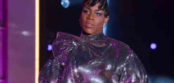 Drag queen Monét X Change wears a sparkly silver outfit as she stands on stage to perform a lip sync at the finale of All Stars 7