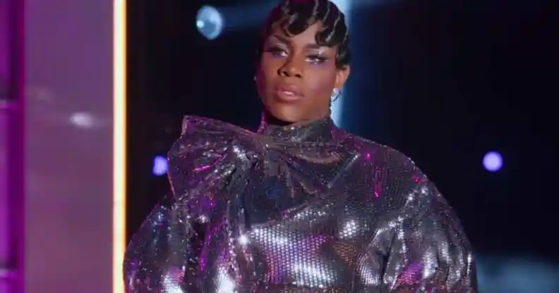 Drag queen Monét X Change wears a sparkly silver outfit as she stands on stage to perform a lip sync at the finale of All Stars 7