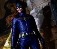 Leslie Grace poses in the purple Batgirl costume
