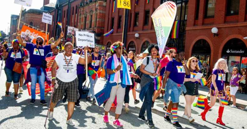 A scene from 2019 Manchester Pride event showing people marching on the streets