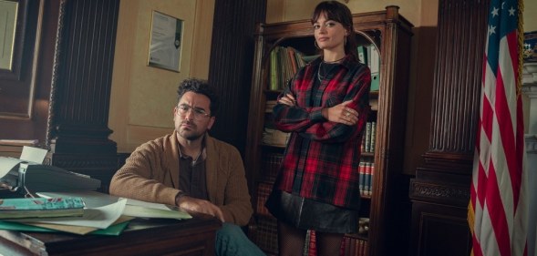 In this photograph, Dan Levy (L) and Emma Mackey stand by one another on the set of Sex Education