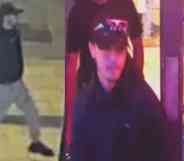 A CCTV image of a man Sussex Police would like to speak to. He is wearing a black cap, black hoodie and grey joggers