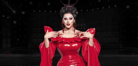Drag Race UK star Cherry Valentine wearing a red dress against a black background in an edited image.
