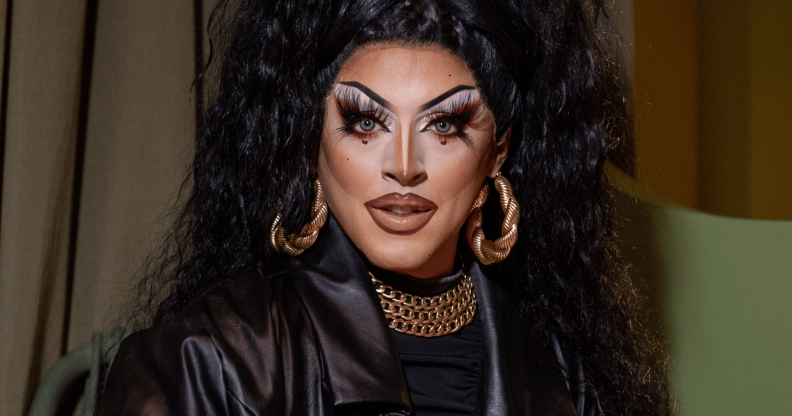 Drag Race Uk star Cherry Valentine wears a dark outfit