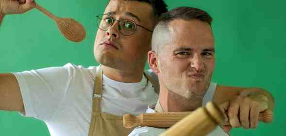 Great British Bake Off stars Michael Chakraverty and David Atherton pose with cooking utensils