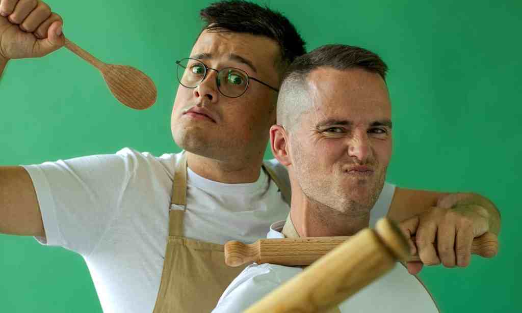 Great British Bake Off stars Michael Chakraverty and David Atherton pose with cooking utensils