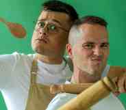 Great British Bake Off stars Michael Chakraverty and David Atherton pose with cooking utensils