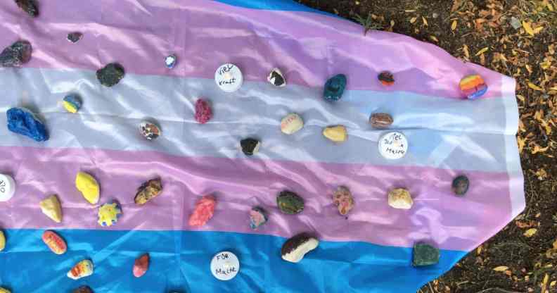 A memorial placed on a trans Pride flag after a young trans man was attacked in Münster, Germany