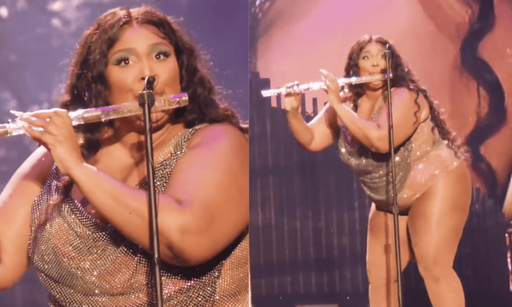 Lizzo wears a sparkly outfit as she plays a crystal flute during a live concert