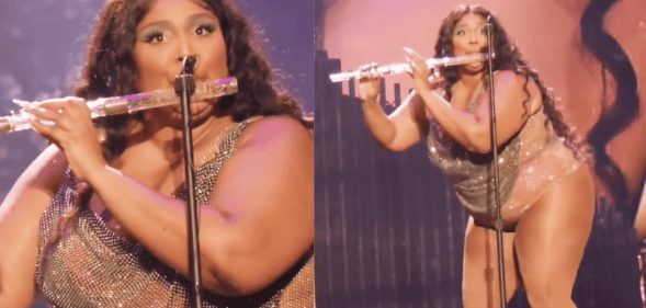 Lizzo wears a sparkly outfit as she plays a crystal flute during a live concert